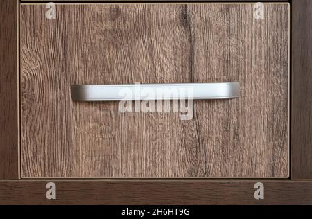 Closeup of single wooden drawer with handle Stock Photo