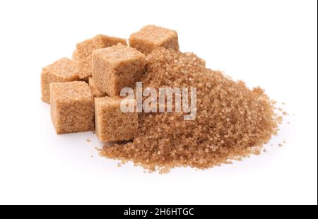 Pile of brown granulated sugar and sugar cubes isolated on white Stock Photo