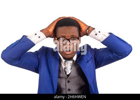 portrait of handsome young businessman stressed and desperate, wearing glasses and a blue jacket looking at the camera, terrorized and in shock, keepi Stock Photo