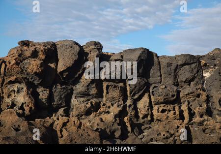 Porous lava volcanic rock around around Playa de la Concha beach in El Cotillo La Oliva municipality of Fuerteventura, Canary Islands Stock Photo
