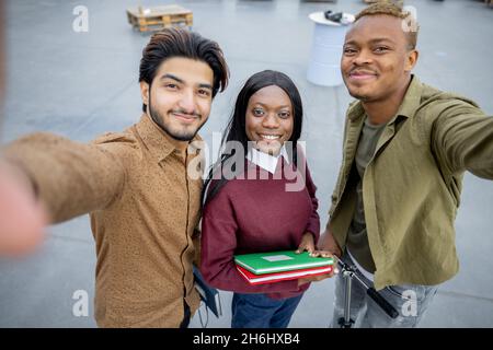 Students looking at camera at university campus Stock Photo