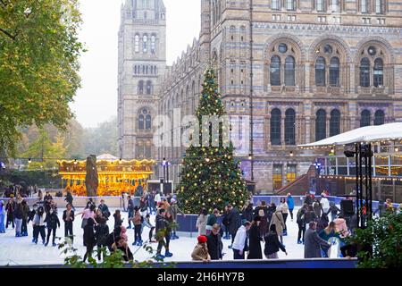 Young people ice skating on the rink at the Natural History Museum after school in November 2021 in London England UK   KATHY DEWITT Stock Photo