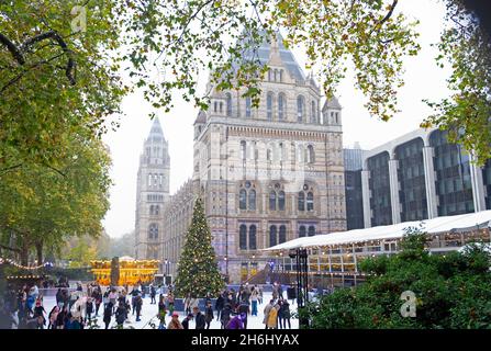 Young people ice skating on the rink at the Natural History Museum in November 2021 in London England UK   KATHY DEWITT Stock Photo