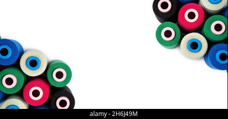 Top view of colored spools of thread on a white background with copy space. Stock Photo