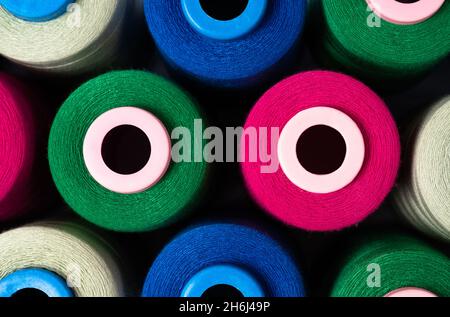 Sewing threads as a multicolored background close up. Pattern of pink, blue and green threads Stock Photo