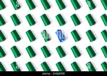 Pattern of spools of sewing thread in green and blue. Stock Photo