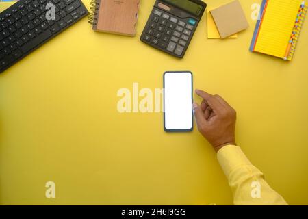 top view of man hand using smart phone on office desk  Stock Photo