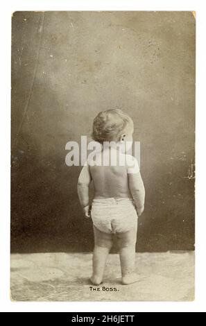 Original Edwardian studio portrait greetings card, of baby in nappy, captioned the Boss, posted 1907, U.K. Stock Photo