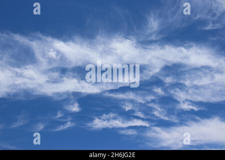 White clouds against blue sky, during a bright Summer day. Stock Photo