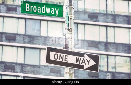 One Way traffic sign at Broadway road, color toning applied, selective focus, New York City, USA. Stock Photo