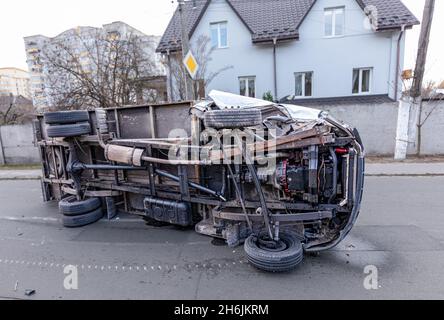 The truck is turned on its side and is lying on the street. Accident. Stock Photo