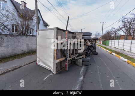 The truck is turned on its side and is lying on the street. Accident. Stock Photo