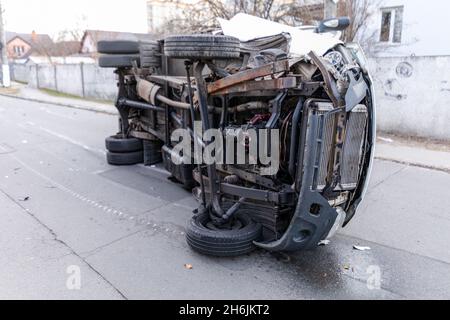 The truck is turned on its side and is lying on the street. Accident. Stock Photo