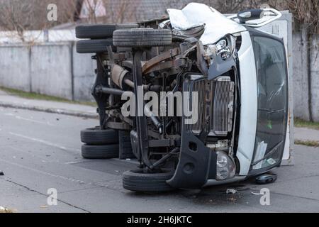 The truck is turned on its side and is lying on the street. Accident. Stock Photo