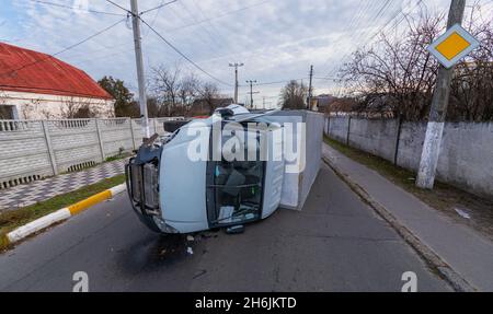 The truck is turned on its side and is lying on the street. Accident. Stock Photo