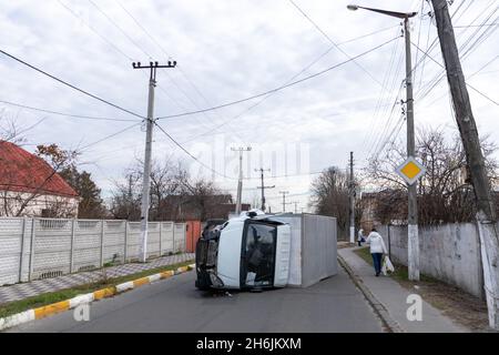 The truck is turned on its side and is lying on the street. Accident. Stock Photo