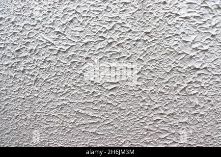 Concrete wall with texture, painted in white, to use as background. Stock Photo