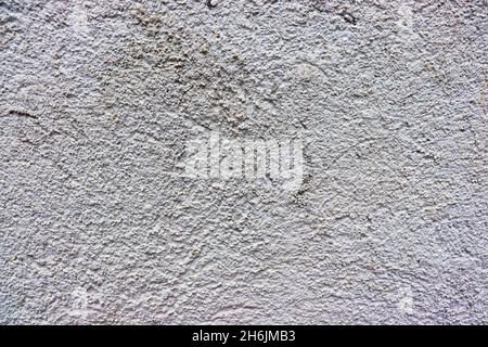 Concrete wall with texture, painted in white, to use as background. Stock Photo