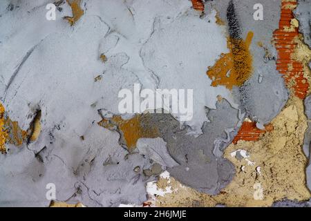 Wall texture with different kinds of cement, showing bricks on the background, with some brushstrokes of paint. Stock Photo
