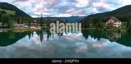 Panoramic of lake Dobbiaco at sunset in summer, Dobbiaco (Toblach, Dolomites, Bolzano province, South Tyrol, Italy, Europe Stock Photo