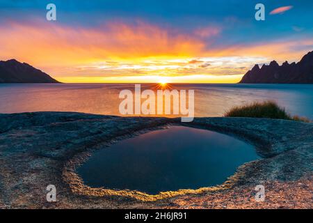 Ersfjord and Steinfjord fjords lit by midnight sun from rock formation at Tungeneset viewpoint, Senja, Troms county, Norway, Scandinavia, Europe Stock Photo
