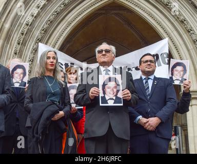 London, UK. 16th November 2021. Retired police officer John Murray with friends and supporters outside the Royal Courts of Justice. Saleh Ibrahim Mabrouk, a Libyan man close to Gaddafi, has been found jointly responsible for the fatal shooting of PC Yvonne Fletcher outside the Libyan Embassy in 1984, in a civil case brought by her former colleague and friend, John Murray. Credit: Vuk Valcic / Alamy Live News Stock Photo