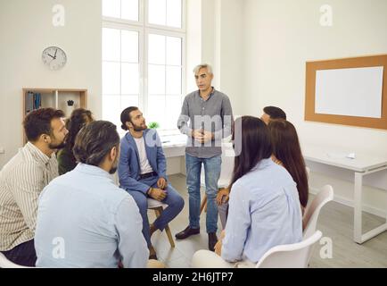 Team of business people or company employees talking during work meeting in office Stock Photo