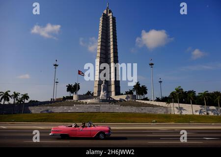Antique car drives by Jose Marti Monument in Plaza de la Revolucion (Revolution Square, Havana, Cuba, West Indies, Central America Stock Photo