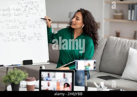 Female teacher explaining math online making video call Stock Photo