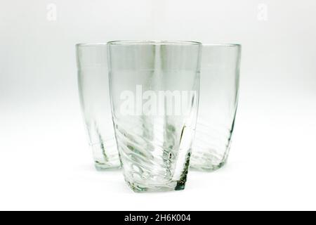 Glass tumblers on white background with selective focus Stock Photo