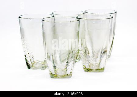 Glass tumblers on white background with selective focus Stock Photo
