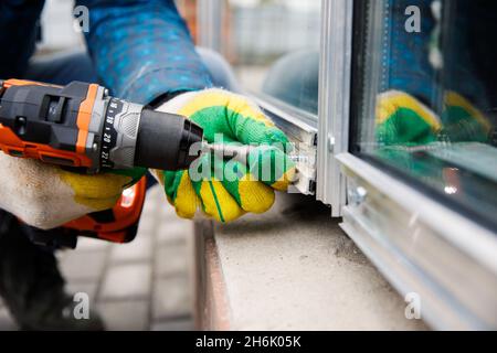 The wizard is engaged in installing windows. Repair work. Stock Photo