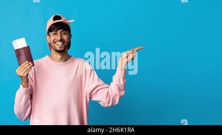 smiling man with plane tickets and passport isolated over blue Stock Photo