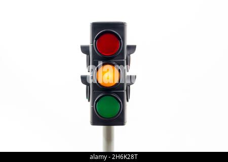 Amber traffic light isolated on a white background. Stock Photo
