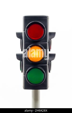 Traffic light isolated on a white background showing an amber light. Stock Photo