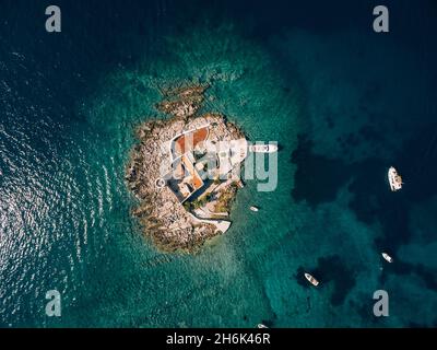 Boats stand near the island of Otocic Gospa. Montenegro. Drone Stock Photo