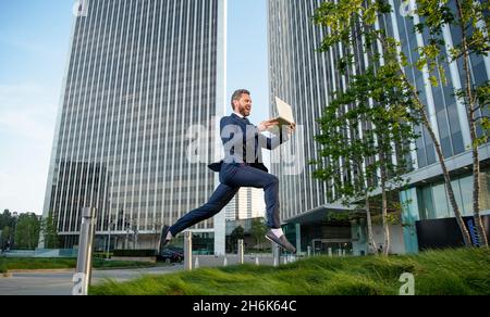 business success. manager man hold pc. hurring running entrepreneur. agile business. Stock Photo