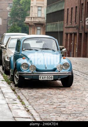 HELSINKI, FINLAND - JULY 2011: Blue retro car Volkswagen Beetle parked on a city street Stock Photo
