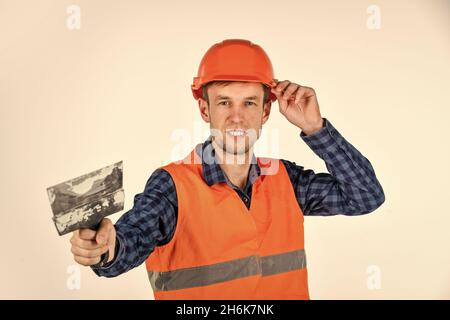 Plasterer in working uniform plastering tool putty knife, new home concept Stock Photo