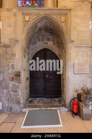 Ancient arched wooden door inside Chichester Cathedral, UK. With thanks to The Dean & Chapter of Chichester Cathedral. Stock Photo