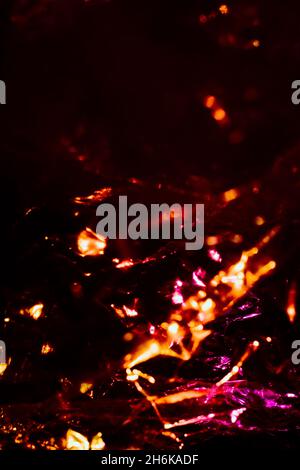 Abstract red background shiny crumpled hologram with sparkles. Trendy neon glowing textured background. Template for creative holiday design Stock Photo