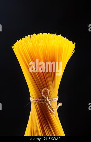 macaroni unprepared raw rope tied spaghetti from durum wheat handmade Stock Photo