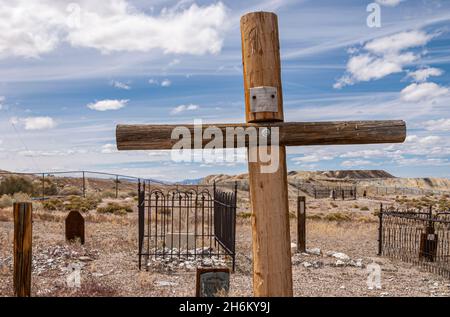 Tonopah, Nevada, US - May 16, 2011: Historic Cemetery. Closeup of Henry Hoppenburger, burned to death, tombstone as wooden cross under blue cloudscape Stock Photo