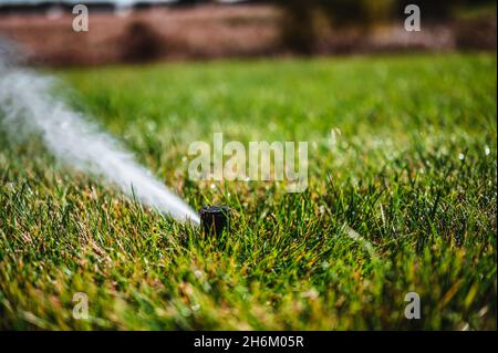 winterizing a irrigation sprinkler system by blowing pressurized air through to clear out water Stock Photo