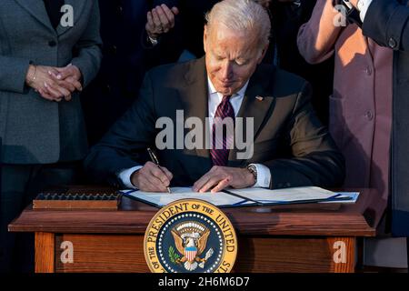 Washington, United States Of America. 15th Nov, 2021. Washington, United States of America. 15 November, 2021. U.S President Joe Biden signs the $1.2 trillion bipartisan infrastructure bill during a ceremony on the South Lawn of the White House November 15, 2021 in Washington, DC Credit: Cameron Smith/White House Photo/Alamy Live News Stock Photo