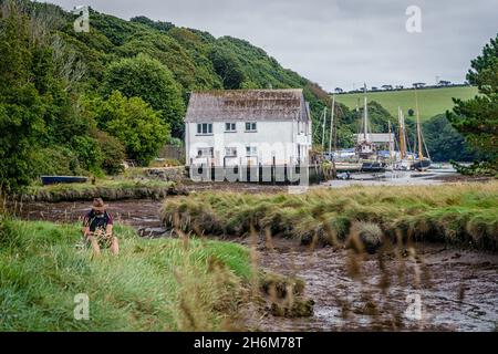 A single artist sits on the river bank and paints the scene Stock Photo