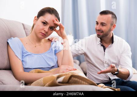 Sad female is depressing and husband is supporting her Stock Photo