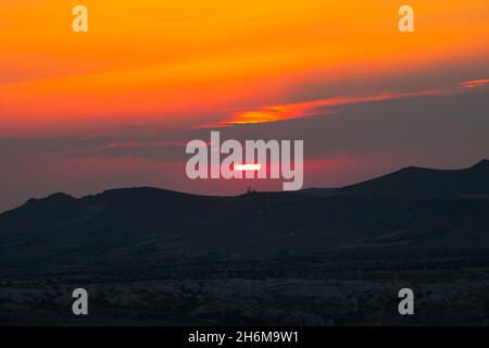 Sunset over the mountains. Sunset scene with silhouettes of mountains with dramatic clouds. Sundown background photo. Stock Photo