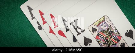 Playing cards and board game figures arranged on a poker table in a casino. Poker card game, winning combination Stock Photo