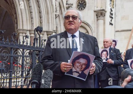 London, UK. 16th Nov, 2021. Retired police officer, John Murray holds a portrait of Yvonne Fletcher outside the Royal Courts of Justice. Saleh Ibrahim Mabrouk, a Libyan man close to Gaddafi, has been found jointly responsible for the fatal shooting of police officer Yvonne Fletcher outside the Libyan Embassy in 1984, in a civil case brought by her former colleague and friend, John Murray. Credit: SOPA Images Limited/Alamy Live News Stock Photo